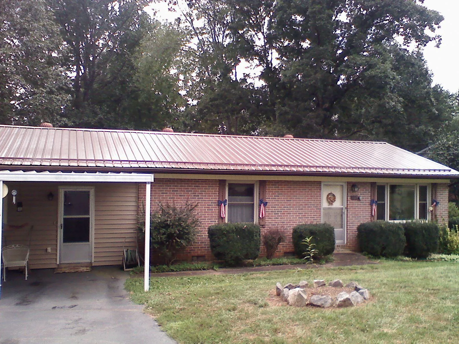 Bronze metal roof and carport on a brick ranch home — Roof Repair work by our crew in Atlantic